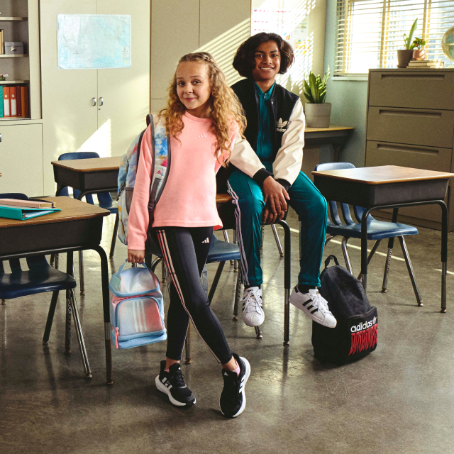 Children in a classroom wearing adidas gear