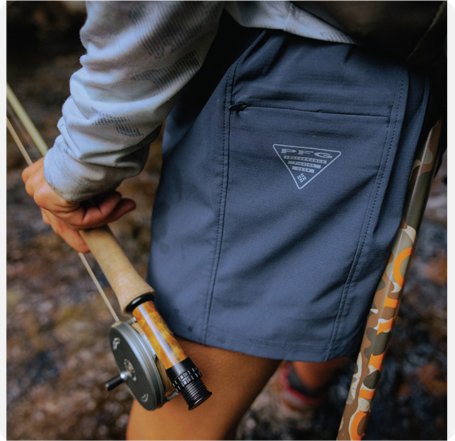 Woman holding fishing rod wearing the Women's PFG Uncharted™ Shorts