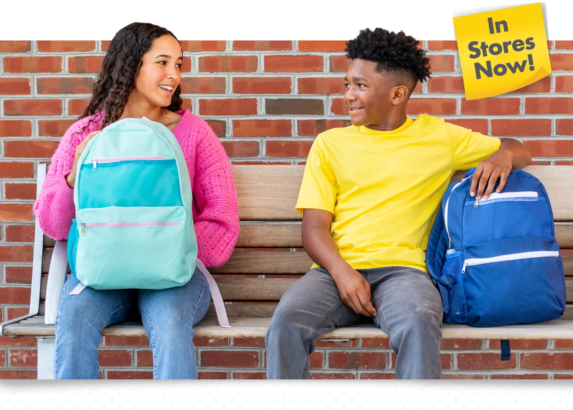 2 students with Dollar Tree backpacks sitting on a bench