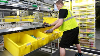 Merchandise is scanned to be tracked as it moves through the new Amazon Fulfillment Center in Sacramento, Calif., on Feb. 9, 2018.