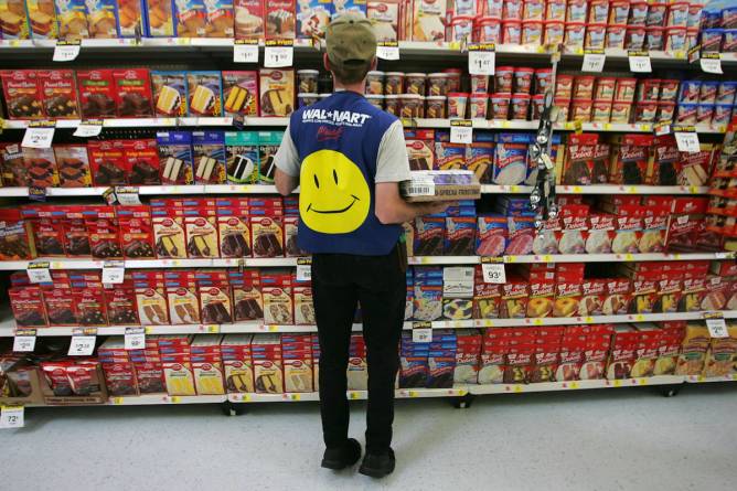 A Walmart employee stocks shelves