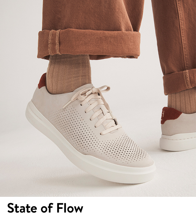 Model wearing perforated sneakers from Cole Haan.