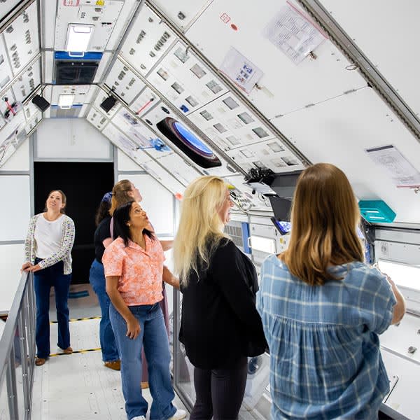 Visitors look around at a space museum exhibit