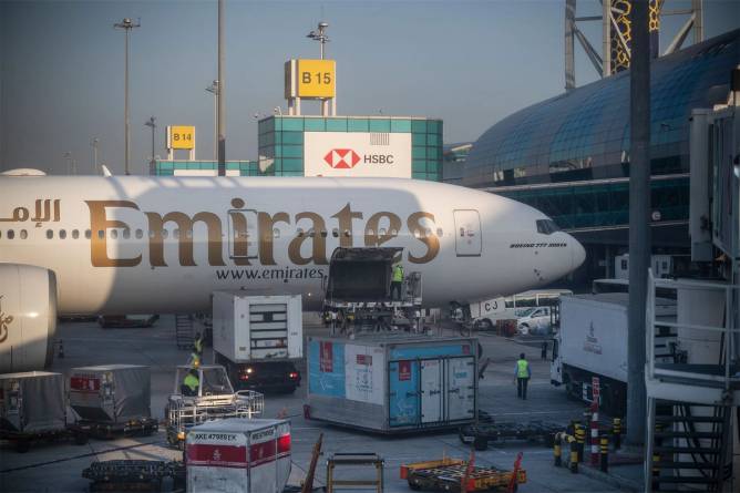 Bags coming off an Emirates airplane