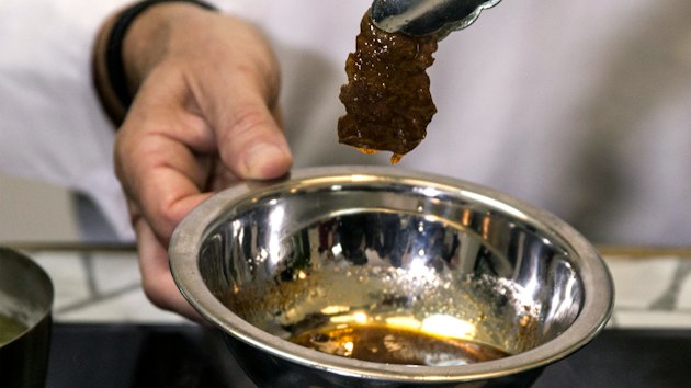 In this Wednesday, Jan. 16, 2019 photo, chef Amir Ilan prepares a lab-grown steak during a presentation by the company Aleph Farms, in Jaffa, Israel.