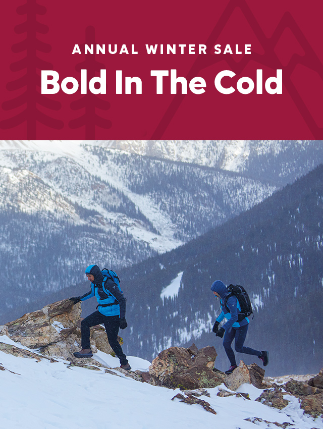 Annual Winter Sale, get forty percent off select styles. A couple hiking on snowy, rocky terrain with headline Bold in the Cold.