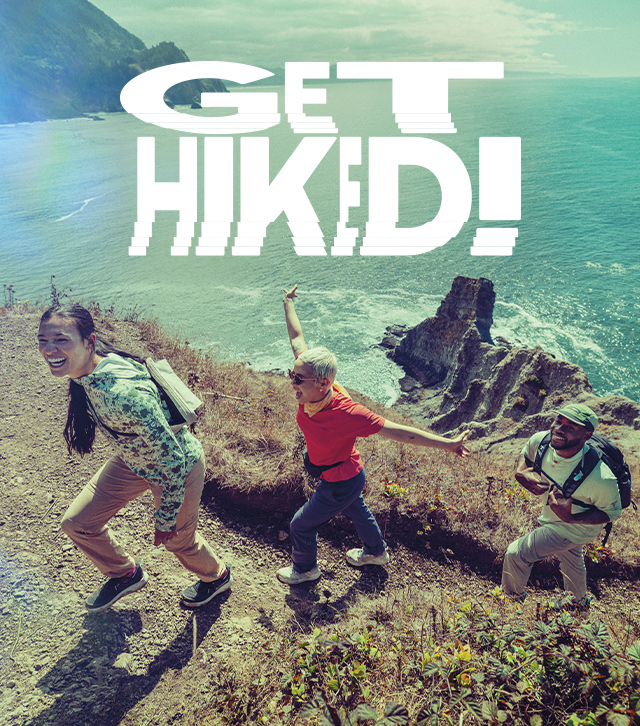 Get hiked. A group of people hiking on a seaside path. 