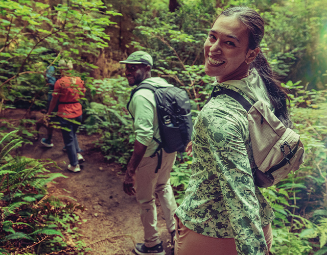 Hikers smiling on a trail