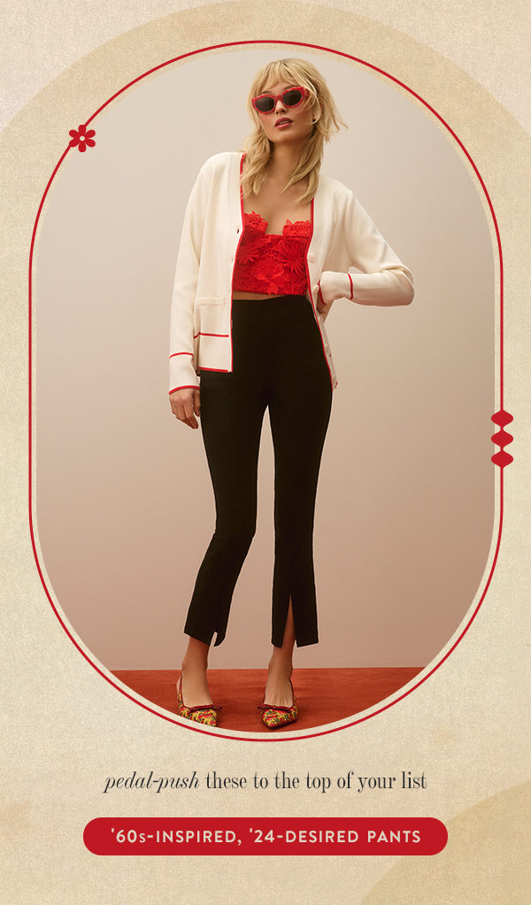 Woman wearing red top and black pants. Shop 60s inspired, 24-desired pants.