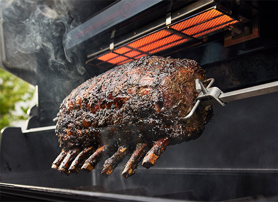 image of Heavy-duty, integrated rotisserie rotates meat to brown evenly while locking in juices.