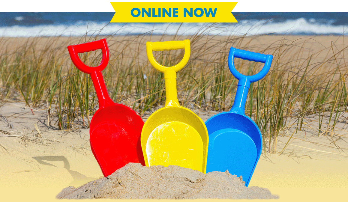 3 colorful plastic beach shovels in sand at the beach