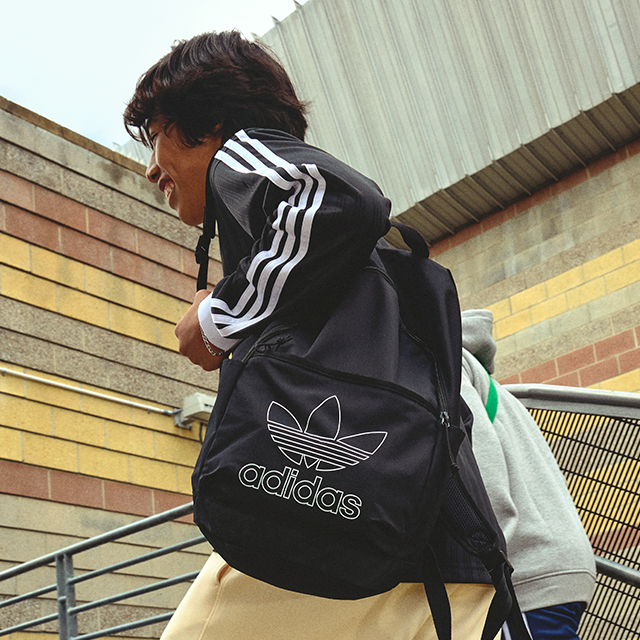 Person with adidas backpack