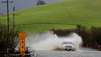 A truck drives through a flooded road in Bloomfield, Calif., Feb. 19, 2024.