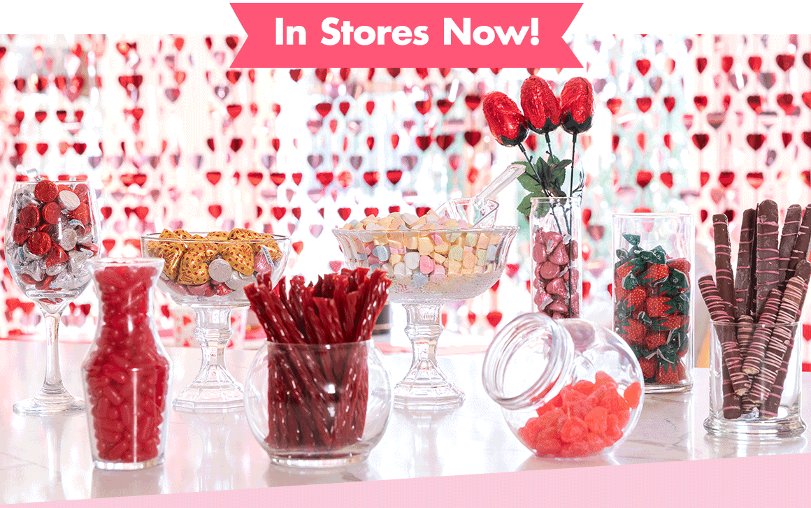 Assortment of glass vases and containers holding Valentine's Day candy