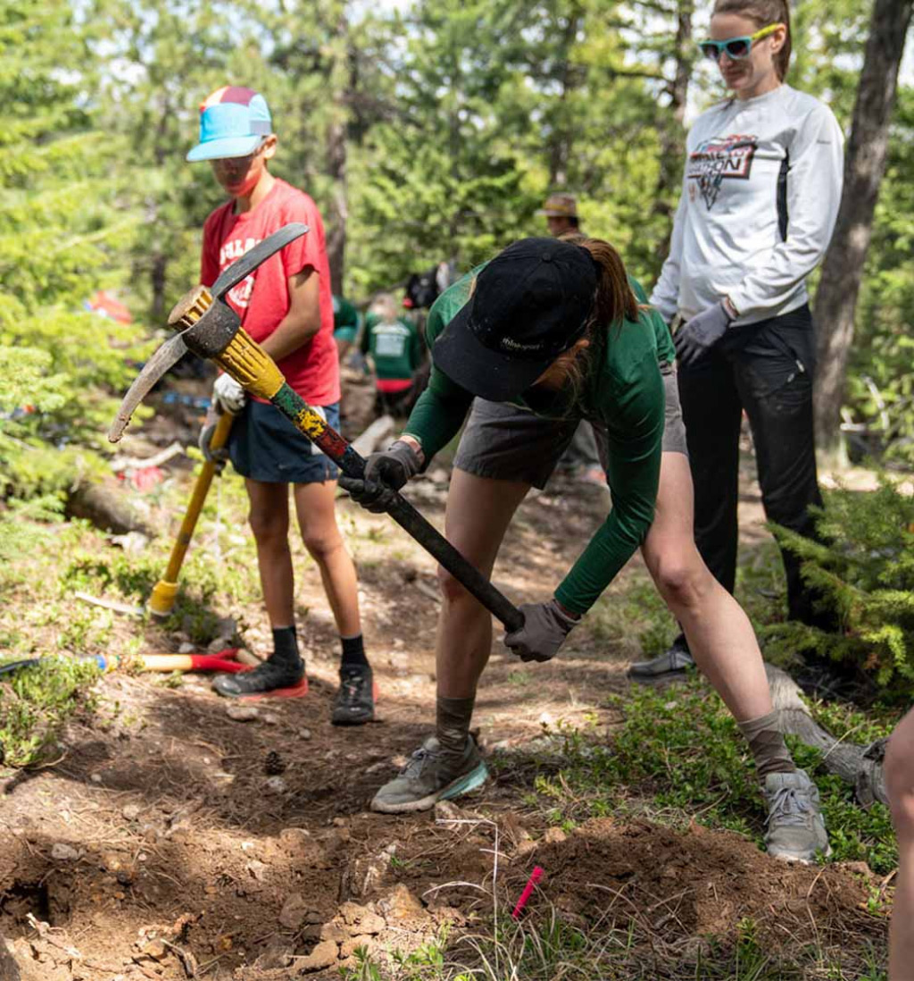 A group of people cleaning up a trail