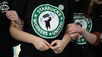 Starbucks employees and supporters link arms during a union election watch party, Dec. 9, 2021, Buffalo, N.Y.