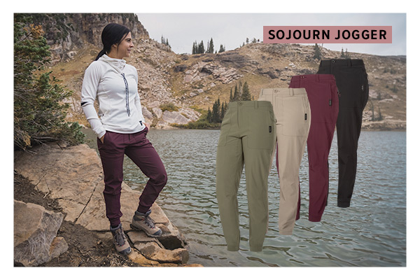 Woman standing on the side of a rocky lake wearing the burgundy sojourn joggers and the white veil top with a image collage of the different colors of the sojourn jogger