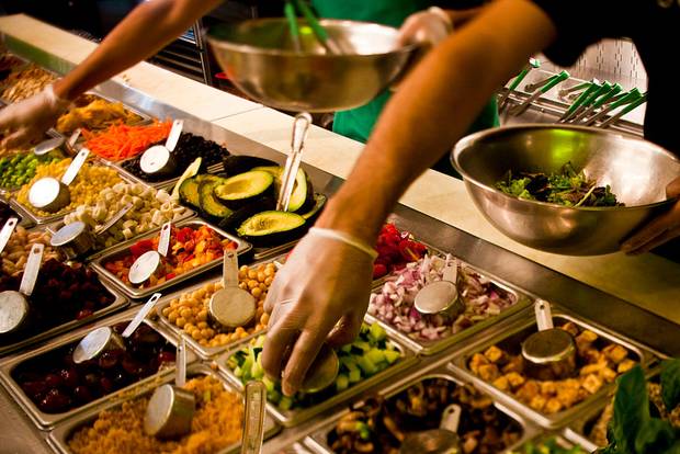 Workers at Sweetgreen assemble salad bowls