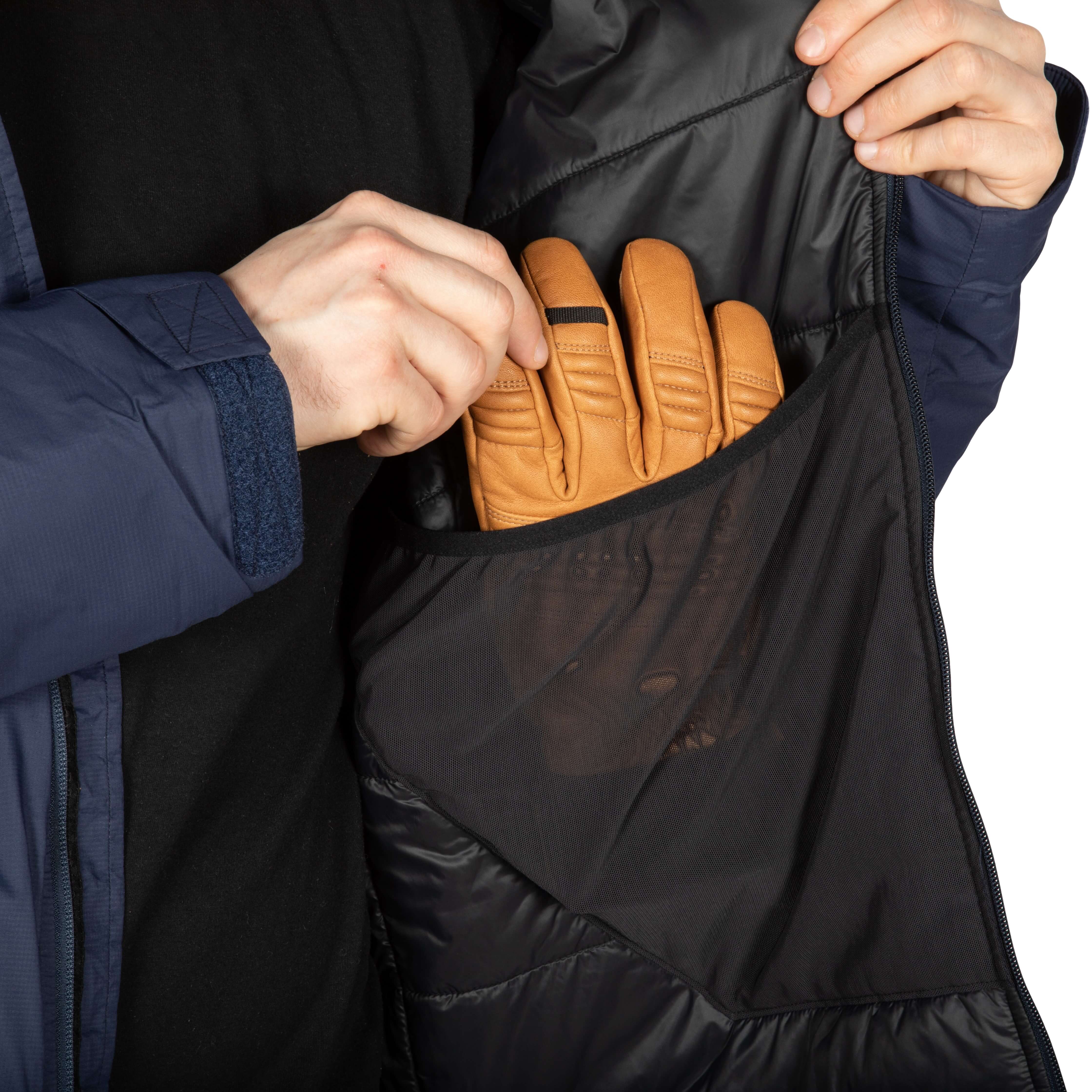 Inner photo of the dump pocket of the Navy Anchor Belay jacket showing putting a glove inside.