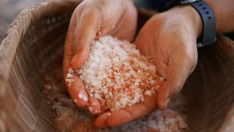 Malia Nobrega-Olivera holds Hawaiian salt, or 'paakai,' Hanapepe, Hawaii, July 10, 2023.