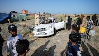 People inspect the site where World Central Kitchen workers were killed in Deir al-Balah, Gaza Strip, April 2, 2024.