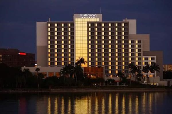 A nighttime shot of the exterior of Pullman Miami Airport hotel