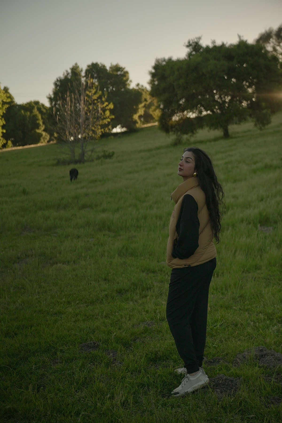 Aditi Mayer with her dog in the distance