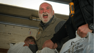 Jose Andres, a Spanish chef and founder of World Central Kitchen, unloads humanitarian food packages, Kherson, Ukraine, Nov. 15, 2022.