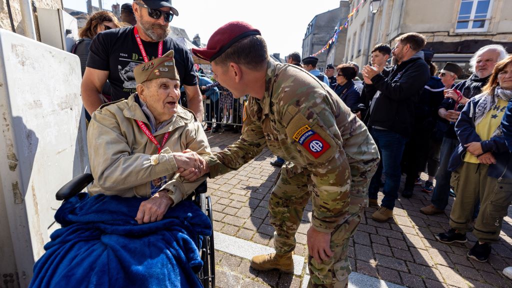 A WWII veteran is welcomed in Normandy during Delta's D-Day Normandy charter trip.