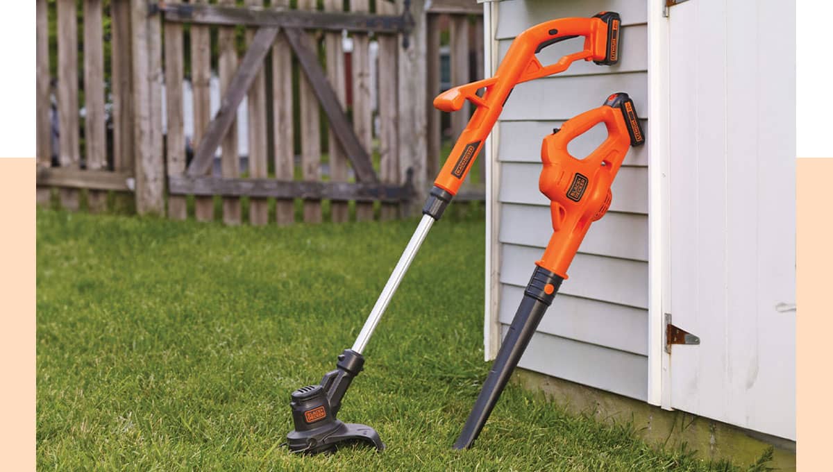 lawn care equipment near a garage