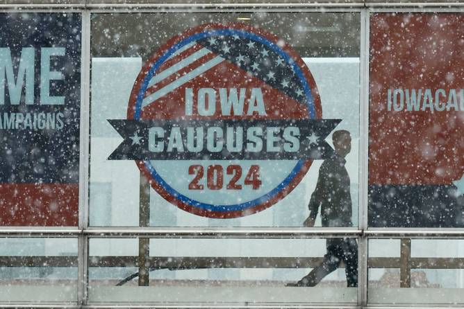 Heavy snow falls as a man walks along the Skywalk system that connects buildings in downtown on January 08, 2024 in Des Moines, Iowa