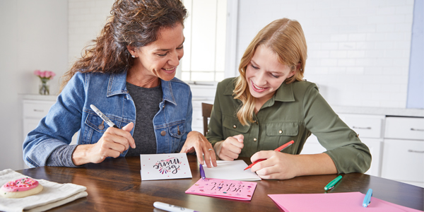 Mother and daughter writing custom cards