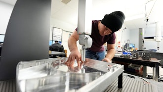 A worker prepares a Hexagon machine at Reata Engineering and Machine Works, Englewood, Colo., Feb.15, 2024.