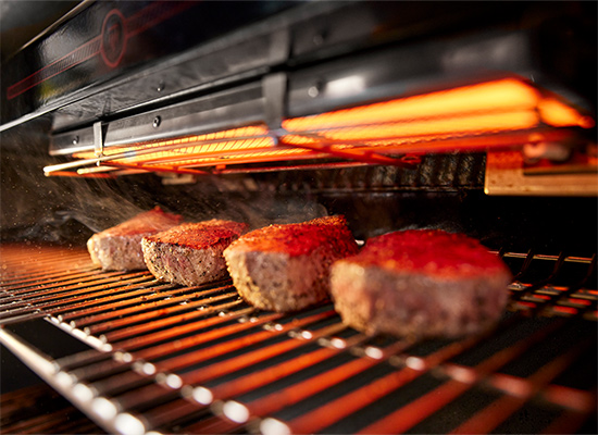 image of Top-down infrared broiler directs blazing heat onto meat for edge-to-edge caramelization.