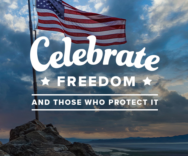 Image with a USA flag on top of a rocky mountain with the Text Overlay "Celebrate Freedom and Those who protect it"