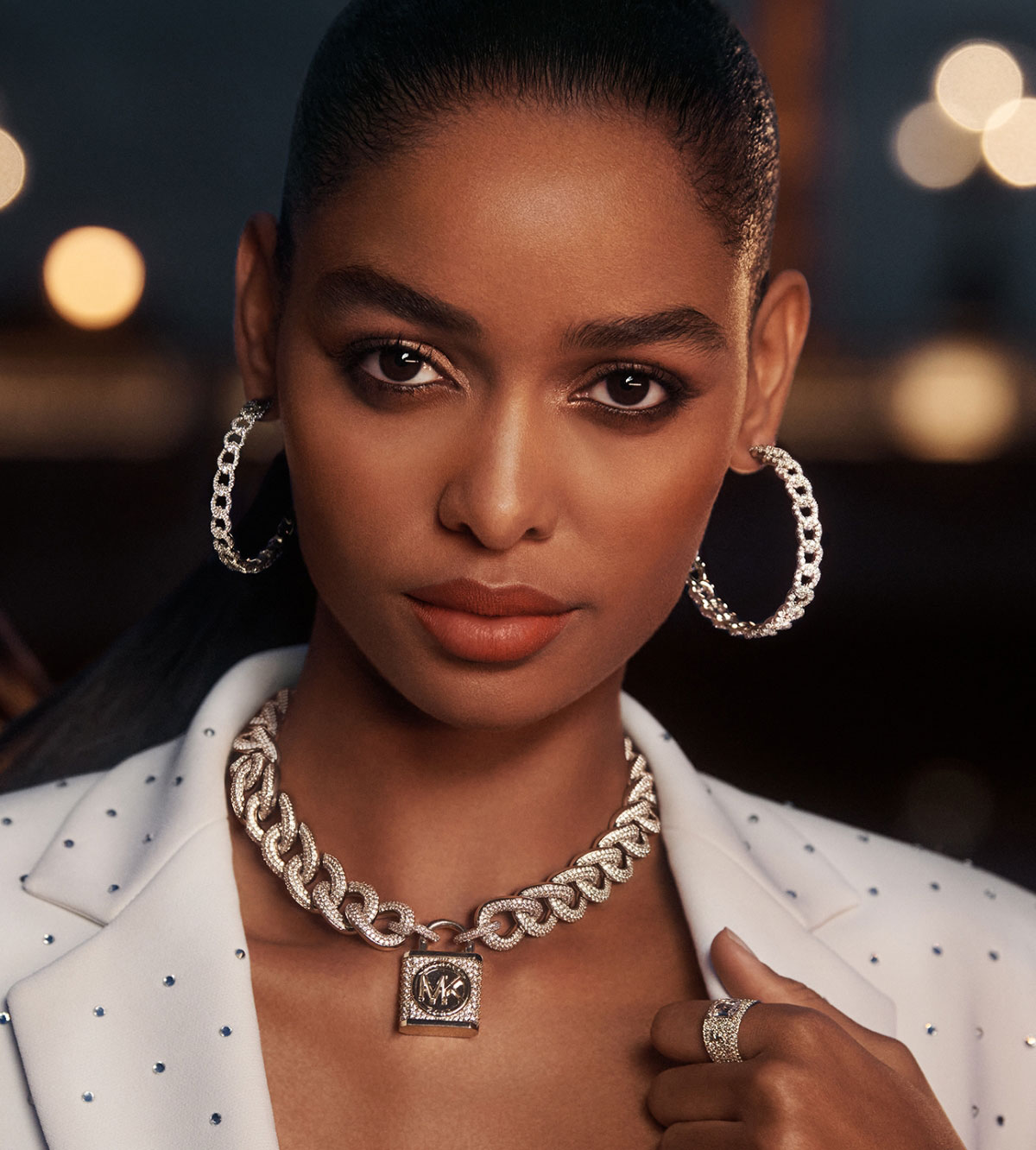 WINTER WHITE Embellished with studs and paired with silver-tone accessories, these holiday-ready pieces prove that crisp white shouldn’t be reserved for the summer months.