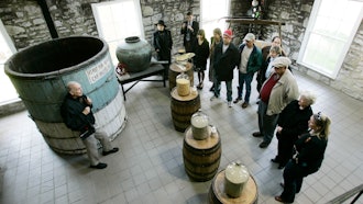 Guide Dave Salyers describes the bourbon-making process to a group touring the Woodford Reserve distillery, Versailles, Ky., April 8, 2009.