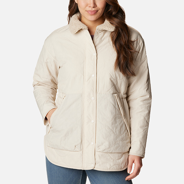 A woman wearing the Birchwood Quilted Jacket in the color stone.