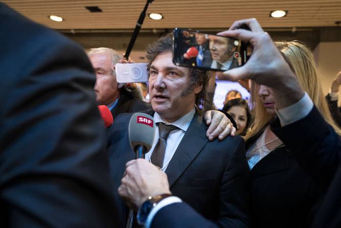 Argentina’s President Javier Milei leaves surrounded by media after delivering a speech at the World Economic Forum meeting in Davos on January 17, 2024.