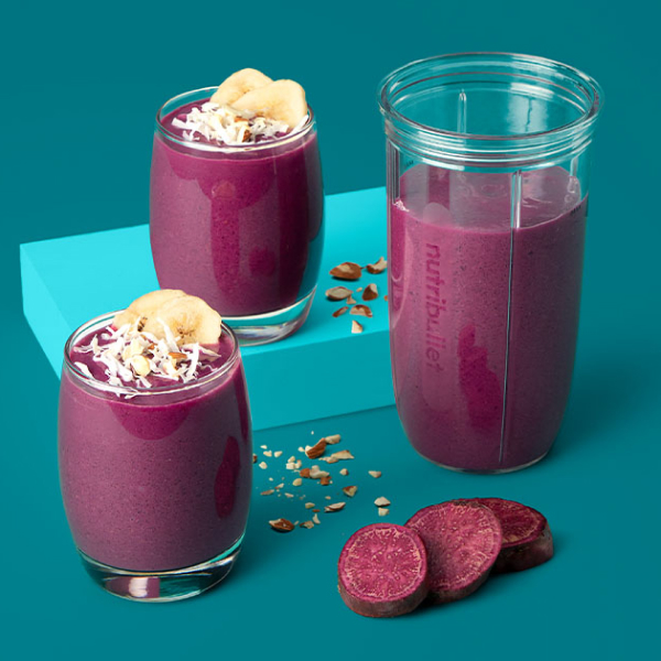 Purple smoothie in two cups and a nutrbullet blender cup.