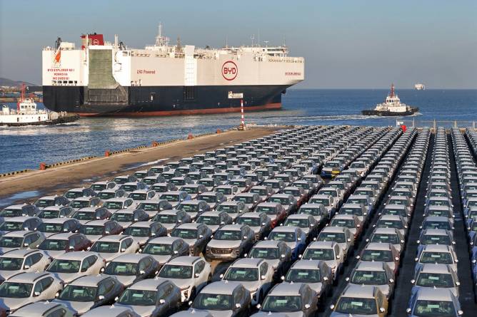 BYD cars lined up in front of its car transporting ship