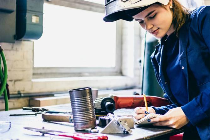 Young woman welding