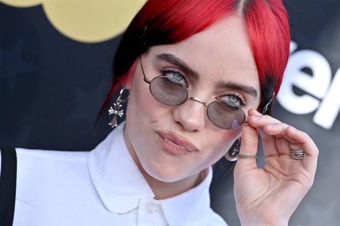 Billie Eilish posing on red carpet at 2024 awards show.