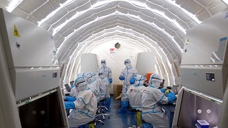 In this file photo released by China's Xinhua News Agency, staff members work in an inflatable COVID-19 testing lab provided by Chinese biotech company BGI Genomics, a subsidiary of BGI Group, in Beijing, June 23, 2020. Members of Congress are raising alarms about what they see as America's failure to compete with China in biotechnology, with risks to U.S. national security and commercial interests.